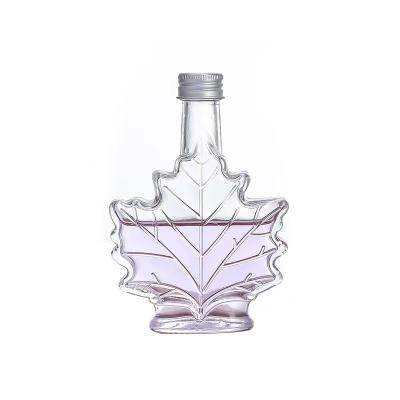 China Latest Design 100ml Maple Leaf Cosmetic Creative Perfume Small Transparent Glass Bottle With Corks for sale