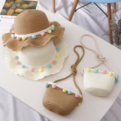 China Portable Big Brim Girls Kids Character Straw Woven Sun Protection Beach Ball Pompom Hat Summer Colorful Floppy Wide Bucket Hat for sale