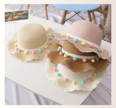 China Portable Big Brim Girls Kids Character Straw Woven Sun Protection Beach Ball Pompom Hat Summer Colorful Floppy Wide Bucket Hat for sale