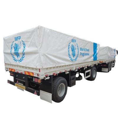 China Graanvervoer 60T platte trailers met mechanische ophanging en tralies Te koop