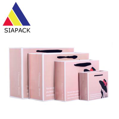 China Recyclable Luxury Paper Packaging Bag Custom Design Matte Lamination With Ribbon Handle Gift Paper Bag for sale