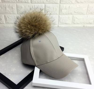 China COMMON COMMON PU Fur Ball Baseball Cap /raccoon Fur Pompom Winter Men/Women Leather Hat for sale