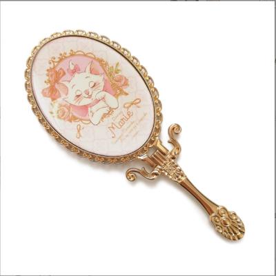 China Custom logo custom hand portable folding cosmetic mirror metal plated handle anime portable table desk cosmetic fold for sale