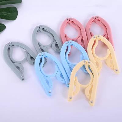 China New classic/postmodern portable plastic folding the hangers multifunctional clothes drying rack travel magic hanger for sale