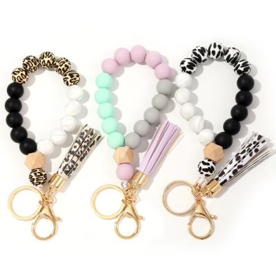 China Key Ring Wristband Bracelet Car Keychain Holder Silicone Women Beaded Bracelet Chains for sale