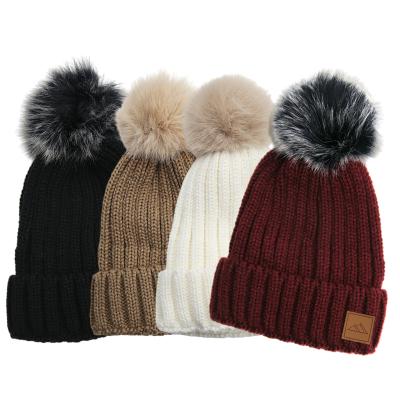 China Custom Leather Fleece Striped Winter Rib Knitted Pompom Beanie Hat JOINT Womens Girls Badge With Faux Fur Pom Pom for sale