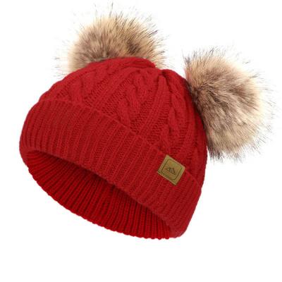 China COMMON Label Custom Cotton Winter Soft Funny Knitted 100% Baby Beanie Cap With Double Faux Fur Pom Pom for sale