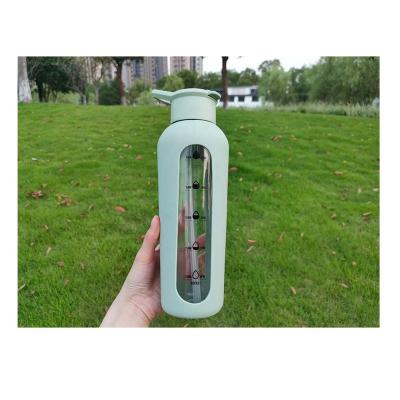 China Recycled Borosilicate Silicone Motivational Glass Water Drinking Bottles Stocked With Time Marker Silicone Sleeve Custom Logo for sale