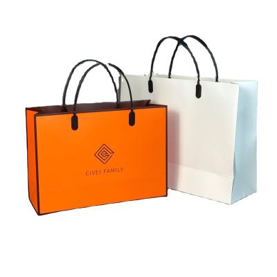 China Recycled Materials Customized Clothing Stores Paper Bag Gift Wholesale Handbag Shopping Paper Bag for sale