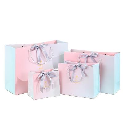 China Recycled Materials Customized Business Gift Bag Wedding Candy Bag Clothing Store Paper Bag With Bowknot Ribbon for sale