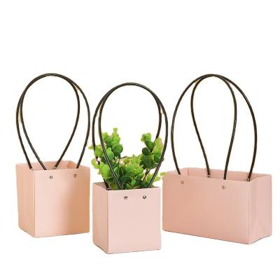 China Recycled Materials Waterproof Flat Trapeze Flower Basket Fashion Rose Kraft Paper Flower Paper Bag Gift Handbag for sale