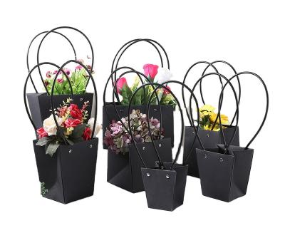 China Recycled materials waterproof flower basket boutique paper bag kraft paper bag with plastic pipe handle for sale