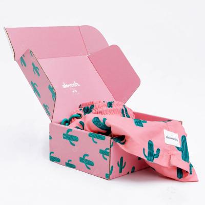 China Custom Materials Pink Color Shipping Cardboard Weight Symbol Pink Symbol Recycled Paperboard Packaging Corrugated Mailing Box for sale