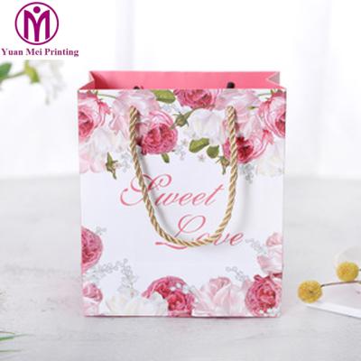 China Recyclable Reusable Custom Design Door Gift Packaging Art Paper Bag With Ribbon for sale