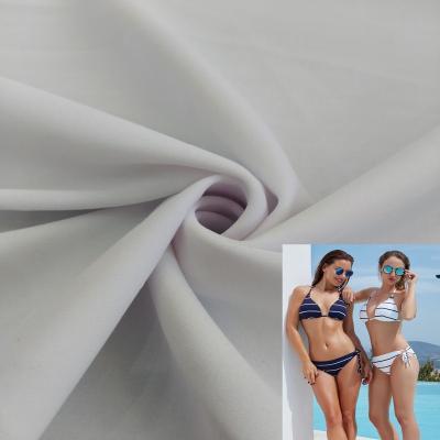 China Jinlong Black Stock 190gsm 85 Polyester 15 Spandex Warp Knit Promotional Fabric For Swimwear for sale