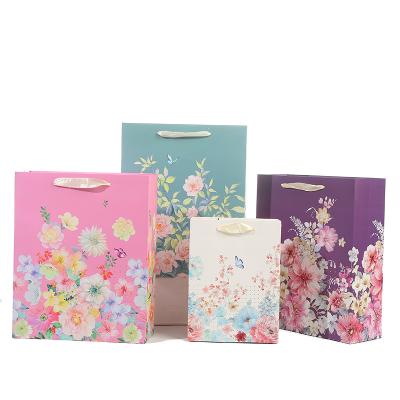 China Luxury Recyclable Boutique Shopping Flower Pattern Printing Large Gift Bags Pack Clothes Packaging Gift Paper Bags With Handles for sale