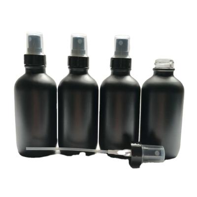 China Hot Sale 60ml Matte Black Empty Personal Care Boston Spray Glass Bottle With Cover Plastic Sprinkler Head for sale