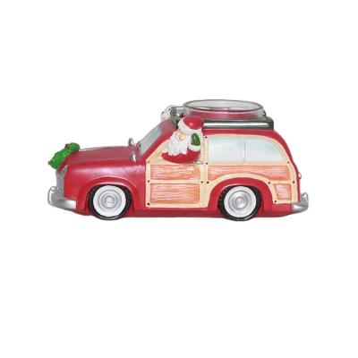 China Hot Sale Handwork Christmas Ornaments Resin Santa Claus And Snowman Driving Car Figurine With Candle Holder for sale