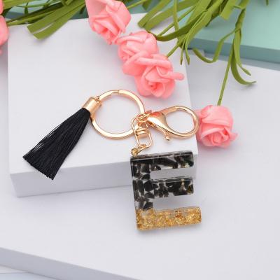 China Shiny Glossy Crystal Epoxy Alphabet Pendant Black Tassel Acrylic Tassel Alphabetic Key Chain for sale