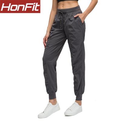 China 2020 OEM Antibacterial Active Workout Pants Custom Made Sports Yoga Fitness Gym Women Joggers With Pockets for sale