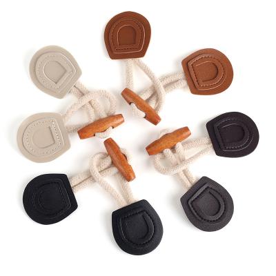 China Dry Cleaning Coat Toggle Buttons OEM Cloth Coat Closure Wood Rope Genuine Leather Toggle Button for sale