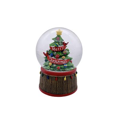 China New World Style 100mm Resin Christmas Tree Snow Globe Musical Crystal Ball For Christmas Home Decoration for sale