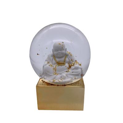 China Worldwide 120MM Electronic Plated Resin Gloden Buddha Snow Globe For Home Decoration Gifts for sale