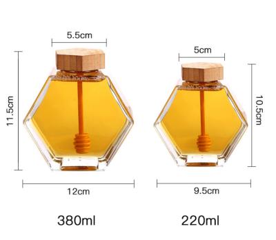 China 100% Biodegradable Jar Hexagon Newell 220Ml 380Ml Glass Bottle With Wood Honey Dipper Gift Packaging Lids Mini Honey Jars for sale