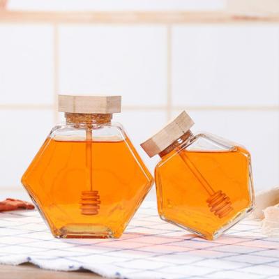 China 100% Biodegradable High Quality Luxury Hexagon Empty Glass Mini Honey Jars With Wooden Dipper For Mixing Honey for sale