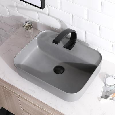 China Modern Unique Design Ceramic Counter Top Wash Sink /matte Black Art Basin For Hotel for sale