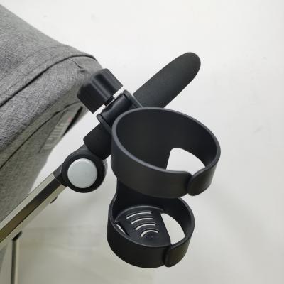 China Multifunctional Cup Holder Two-in-one Universal Black Stroller Bottle Cup Holder Pram Wheelchair Cup Holder for sale