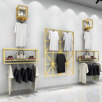 China Modern Unique Gold Display Rack Metal Shop Wall Mounted Shelf For Clothes Garment Hanging Pants Suit for sale