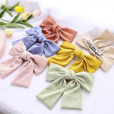 China Fashionable wholesale girls ponytail fabric satin fabric big hairpin bow top clip spring clip girls for sale