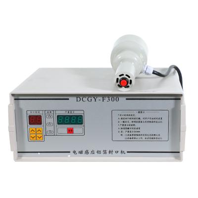 China DCGY-F200 Manual Food Aluminum Foil Glass Bottle Lid Cap Induction Sealer Plastic Sealing Machine for sale