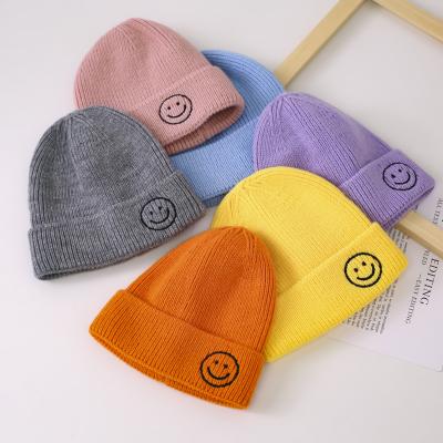 China COMMON Wholesale High Quality Custom Warm Children's Knitted Beanie Baby Smiley Face Embroidered Label Winter Kids Hat for sale