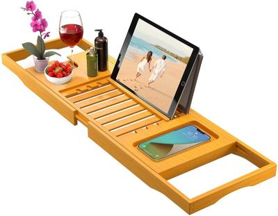 China Sustainable Adjustable Bathtub Tray Anti Slip Grips Bamboo Storage Tray With Book Phone Ipad Bamboo Holder for sale