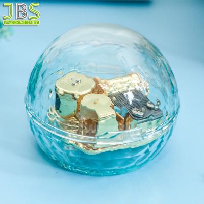 China Suitable for any occasions clear round shape music box gift with 18 note musical movement for sale