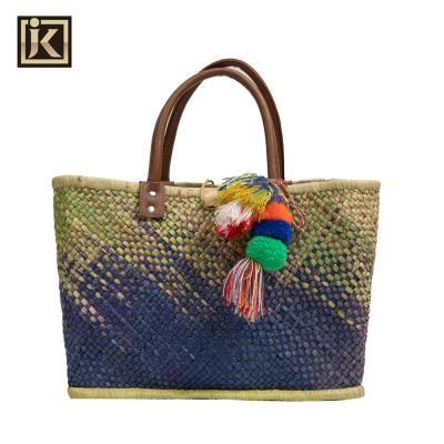 China Fashion Market JAKIJAYI Tote Straw Beach Bag Bamboo Wheat Leather French Handle with Pom Pom Tassel for sale