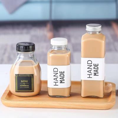 China Wholesale Import 250ml 300ml 350ml 500ml 1000ml Beverage Manufacturing Twist Off Cap Juice Beverage Glass Drinking Bottle for sale