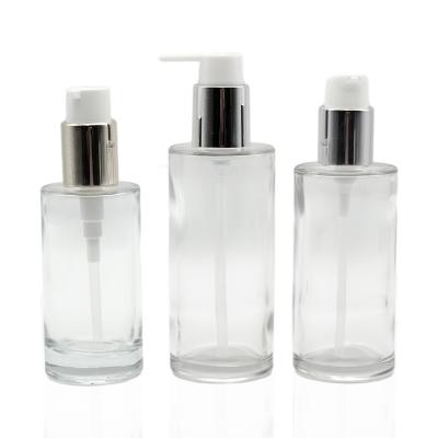 China Clear Cosmetic Glass Bottle 100ml 120ml 150ml Cylinder Skin Care Lotion Cosmetic Glass Pump Bottle for sale