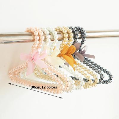 China CLASSIC Wholesale Plastic 30CM Display Pearl Coat Cloth Beaded Hanger For Clothing for sale