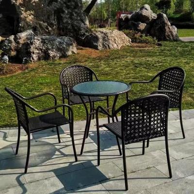 China Modern Backyard Dining Table Hotel Rattan Glass And Black Steel Five Piece Set Contemporary Furniture Sofa for sale