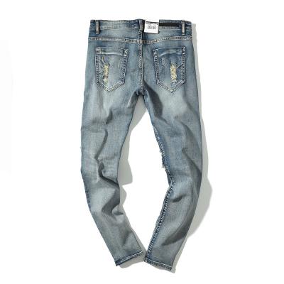 China Breathable Hot Sale High Street Jeans Washed Rock Old Knife Made Knee Cut Small Feet Men's Jeans Pants for sale