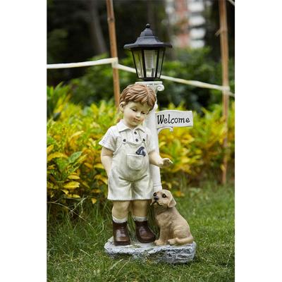 China Solar Europe Boy Statue With Light Welcome Sign Garden LED Statues For Backyard Resin Crafts for sale