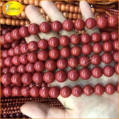 China 100% Natural Color Smooth Red Coral Round Beads Natural Coral Jewelry Manufacturer for sale