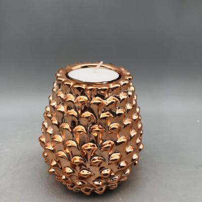 China Factory direct sales eco-friendly pinecone shape plated gold porcelain t-light holder for sale