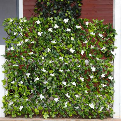 China Promotional Indoor Outdoor Wall Easily Assembled Artificial Foliage Plant With Flowers Fence Leaves Fencing For Home Decoration for sale