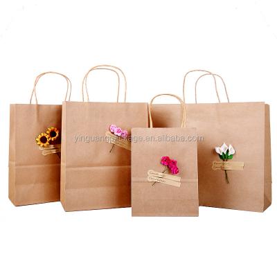 China Recyclable Handmade Brown Kraft Paper Gift Bag Custom Craft Paper Bag With Artificial Flowers for sale