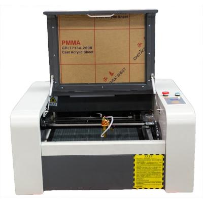 China Water-cooled Portable mini CO2 laser engraver machine laser cutter machine 4040 50W 60W for sale