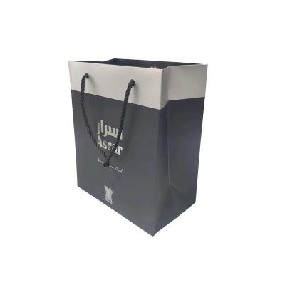 China Recycled Materials Custom Luxury Black Clothes Store Retail Packaging Gift Carry Bags Boutique Shopping Paper Bags With Your Own Logo for sale